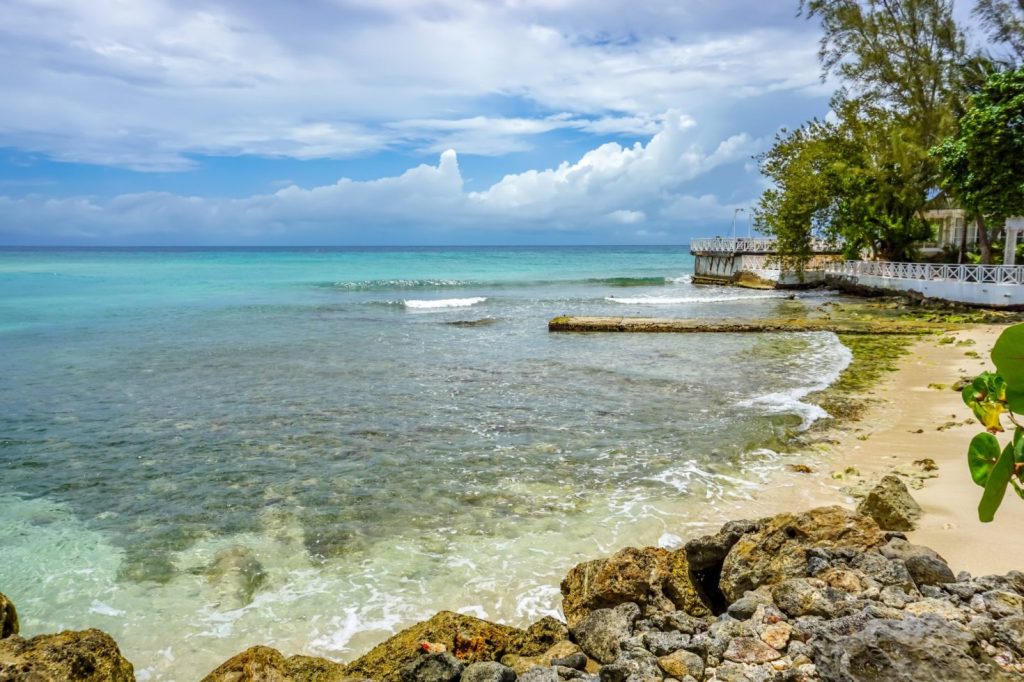 Blue water and sand of a beach in Jamaica.